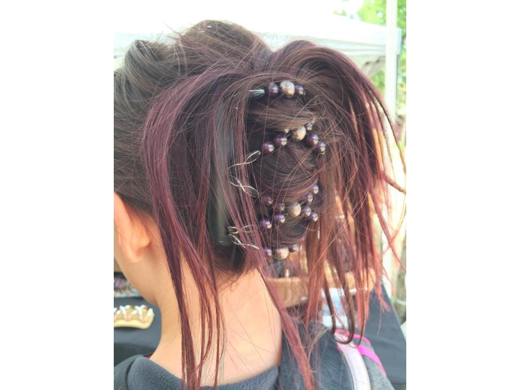 Young Lady with an African Butterfly Dalena Hair Comb in her hair in a cascade hairstyle