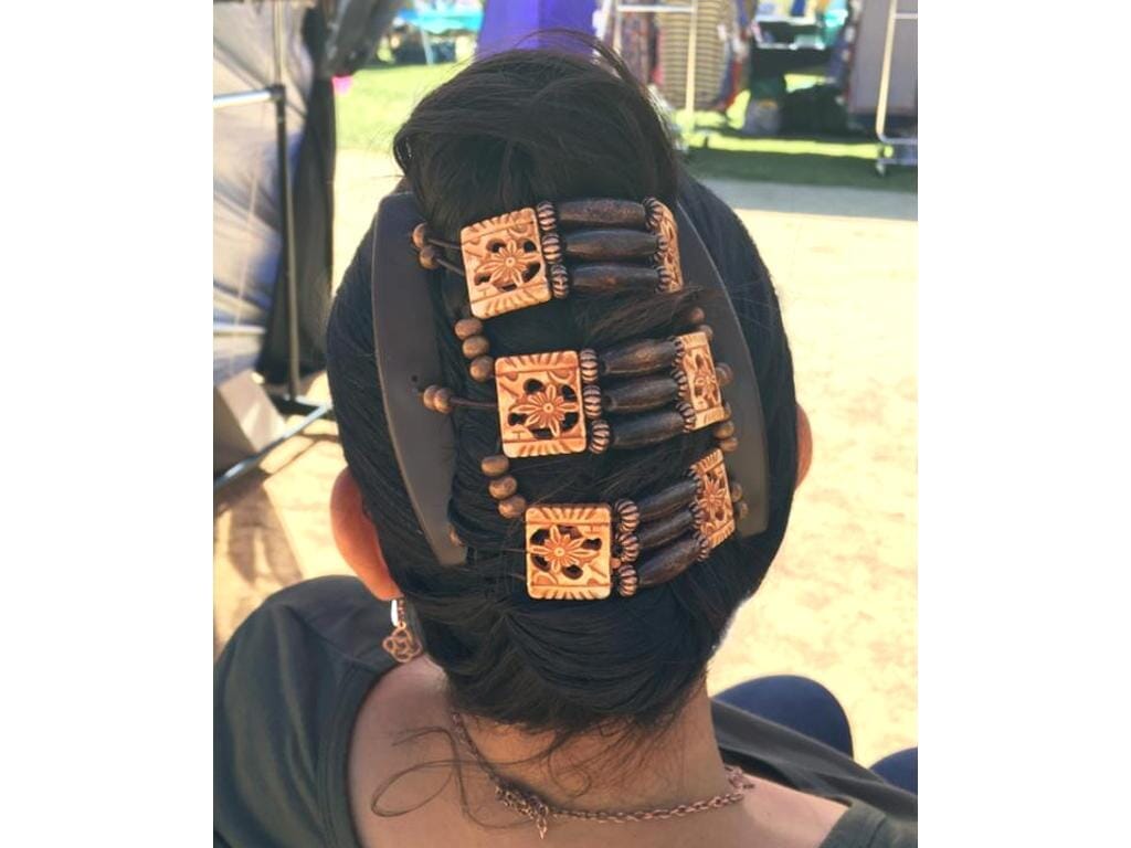 Woman showcasing our African Butterfly Tripla Thick Hair Comb in a french twist hairstyle