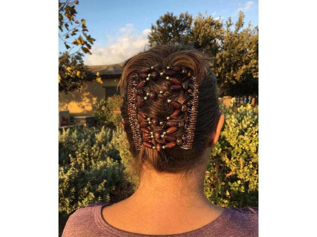 Woman showcasing our African Butterfly 11 Tong Wire Hair Clip in a cascade hairstyle