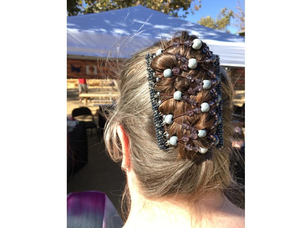Woman showcasing our African Butterfly 11 Tong Wire Hair Clip in a french twist hairstyle