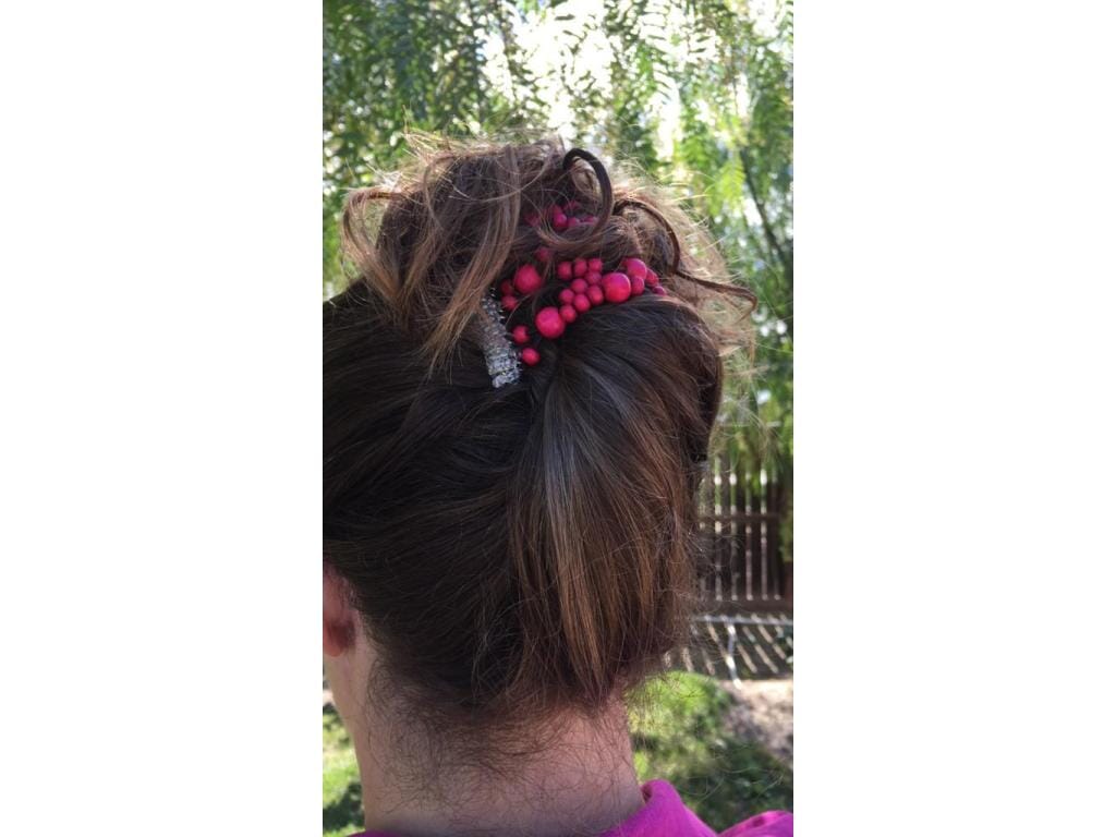 Woman wearing our African Butterfly 7 Tong Wire Hair Clip in a high french twist hairstyle