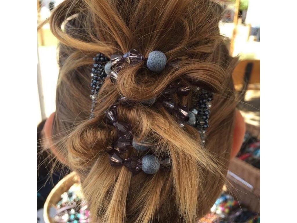 Young woman wearing our African Butterfly 7 Tong Wire Hair Clip in a messy bun hairstyle