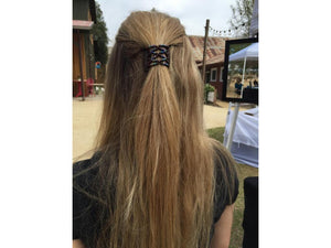 Woman wearing an African Butterfly Black LadyBug Hair Comb with rainbow beads in a sides up hairstyle at a craft show