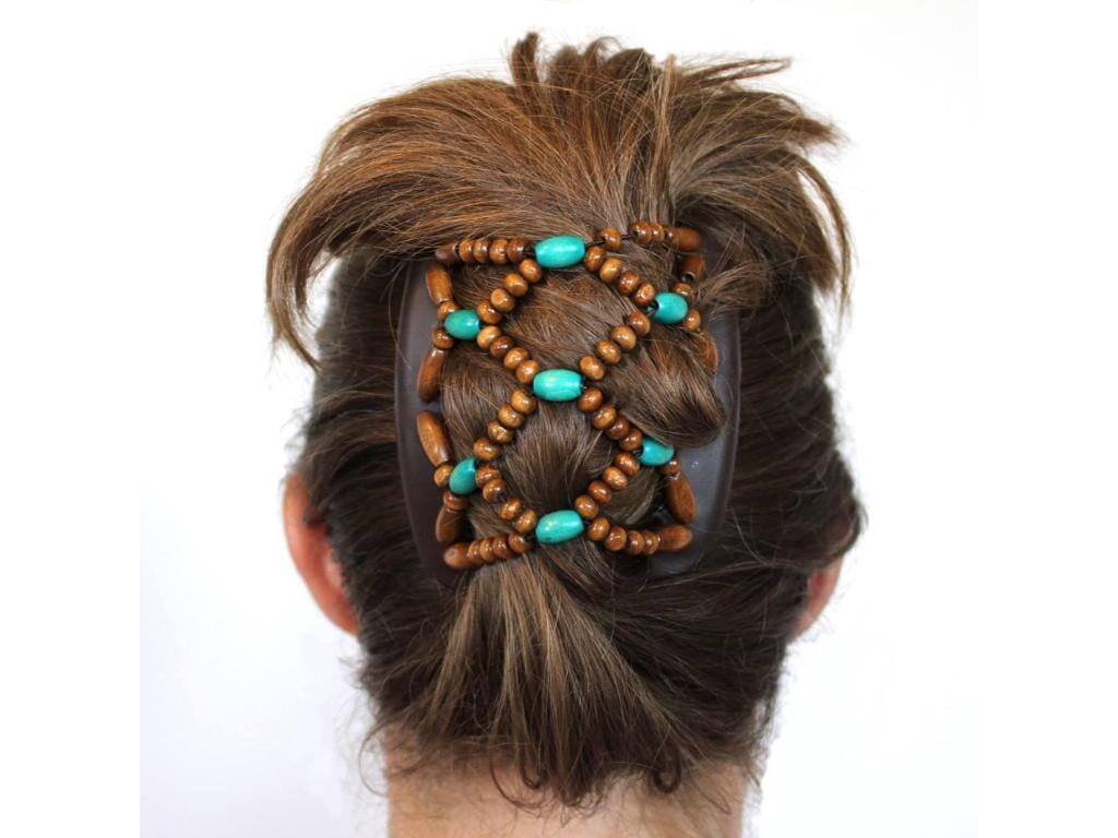 Woman wearing a brown African Butterfly Ndebele Hair Comb with brown and turquoise beads in a cascade hairstyle, white background