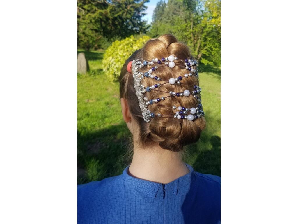 Young woman showcasing our African Butterfly 11 Tong Wire Hair Clip in a braided bun hairstyle